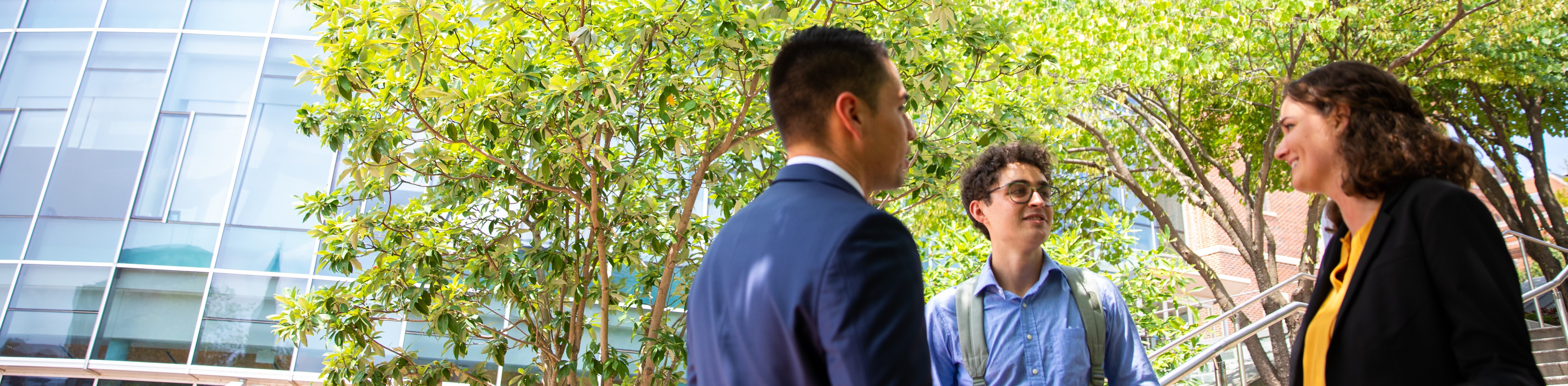 diverse group of students smiling and talking in the classroom